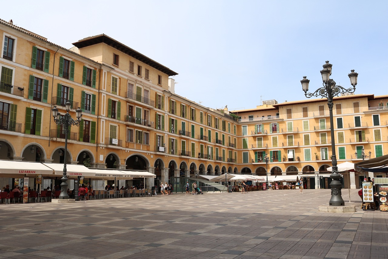 Plaça Major in Palma de Mallorca, a popular tourist destination in Spain, showcasing beautiful architecture and bustling activity.